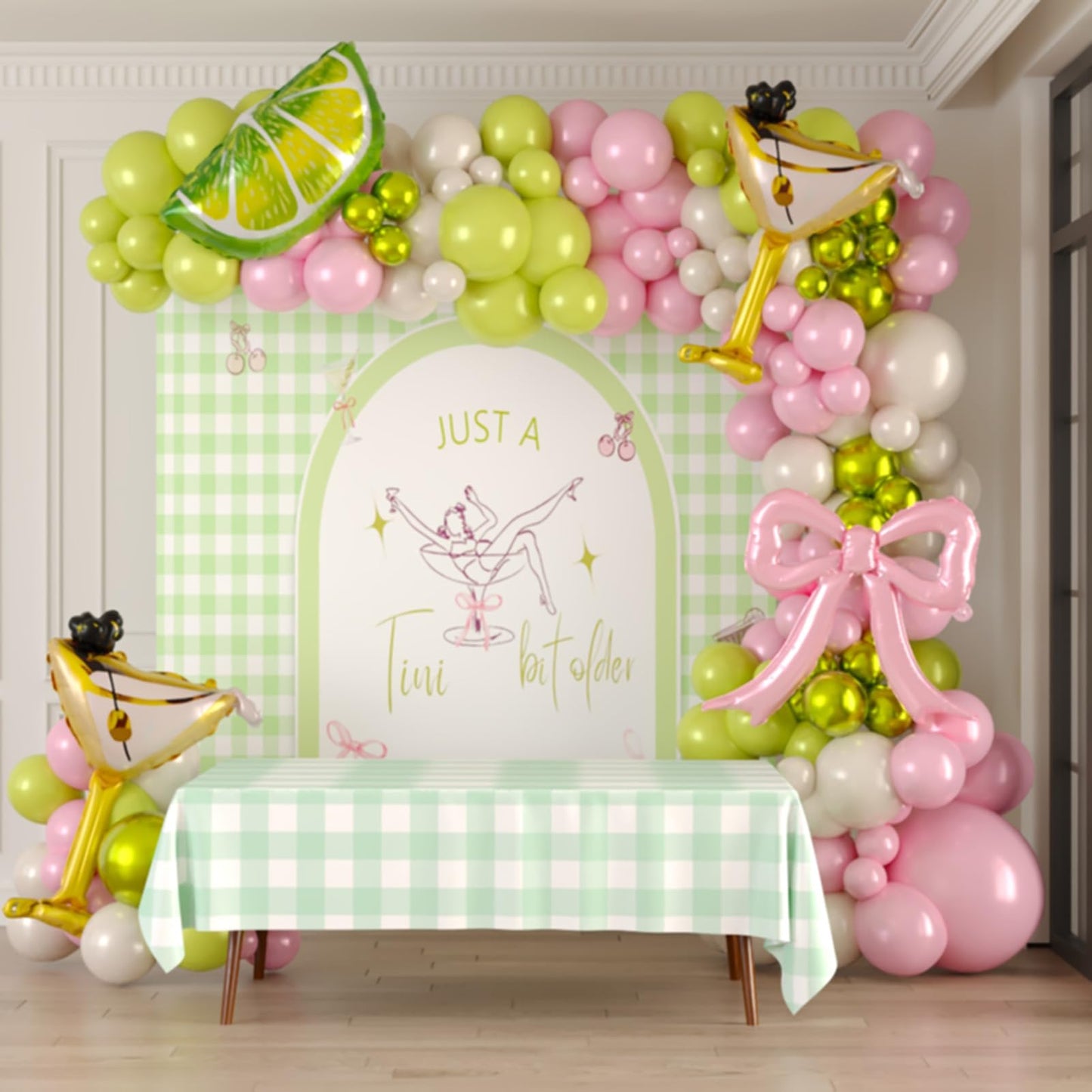 A Tini Bit Older balloon garland arch kit with Pink oilve green